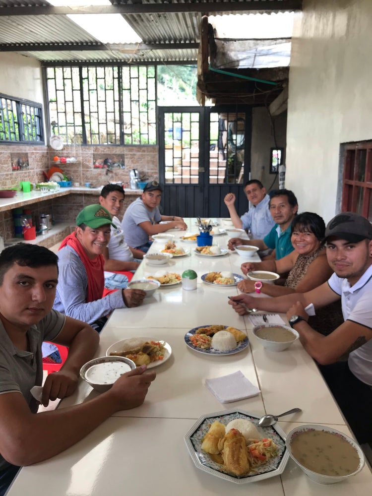 Group of people having lunch around a long table