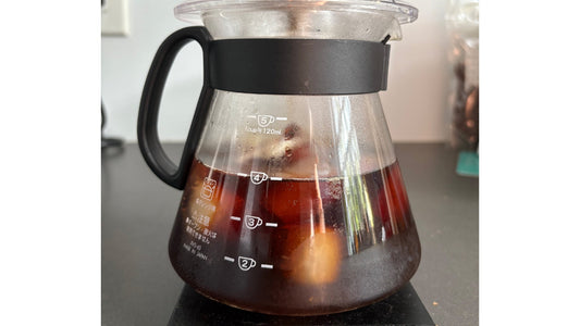 Pitcher of cold coffee with ice cubes