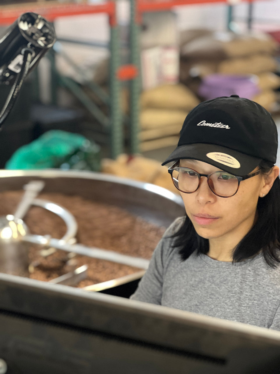 Person wearing a hat looking at a computer screen