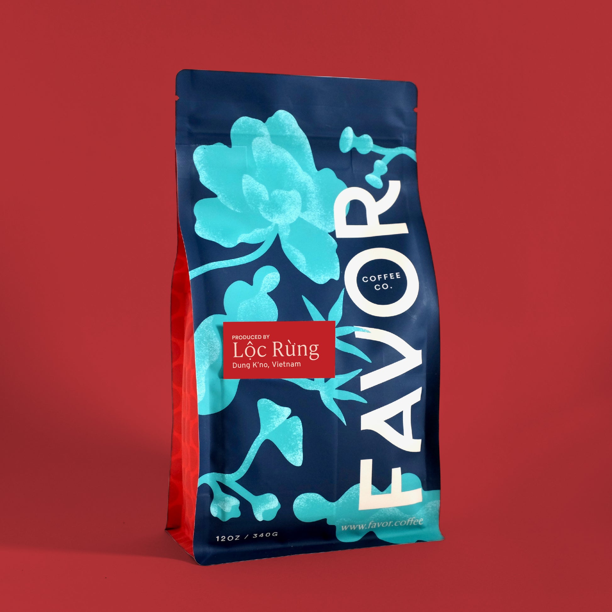 Coffee bag with blue floral design and 'FAVOR' branding on a red background
